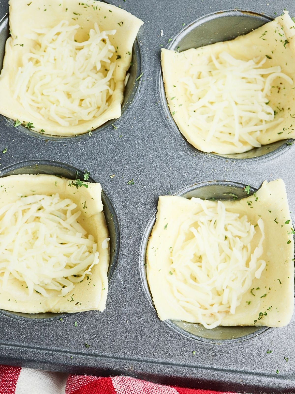 closeup of puff pastry squares with mozzarella cheese