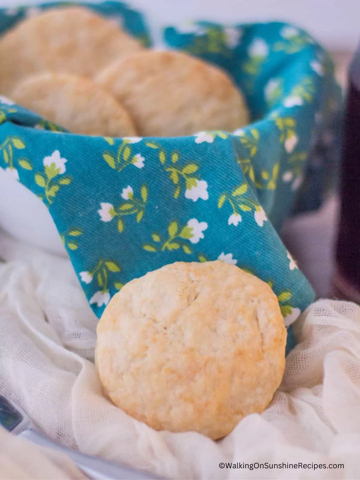 homemade biscuits in basket with aqua napkin.