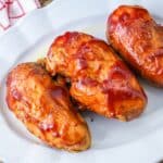 3 bbq chicken breasts served on a white platter