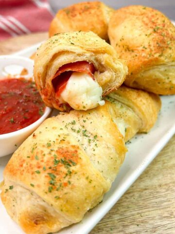 Crescent rolls stuffed and baked with pepperoni slices and cheese sticks.