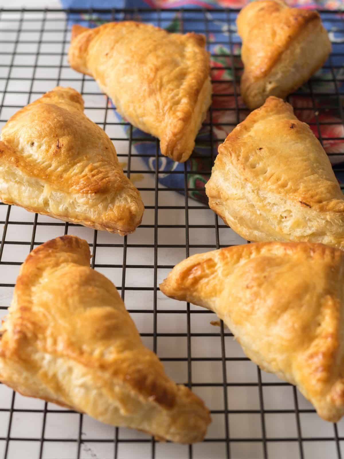 Baked puff pastry pockets on a cooling rack