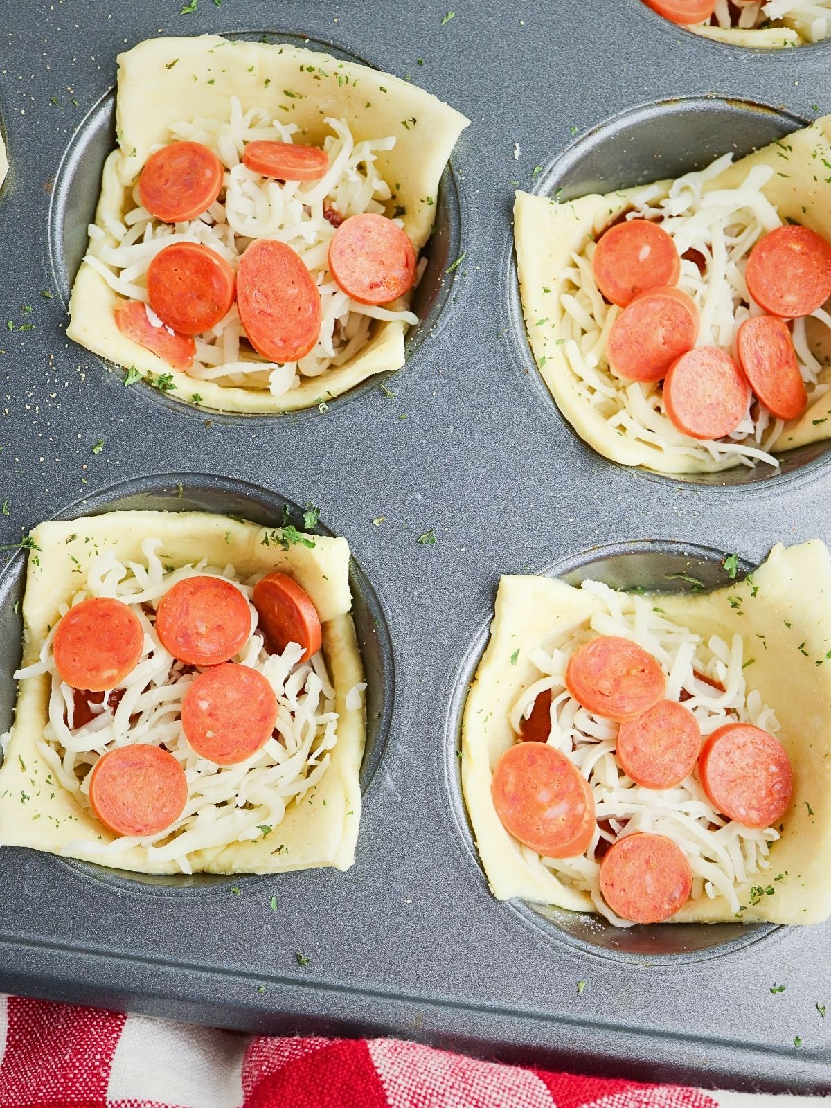 mini pepperonis added on top of cheese