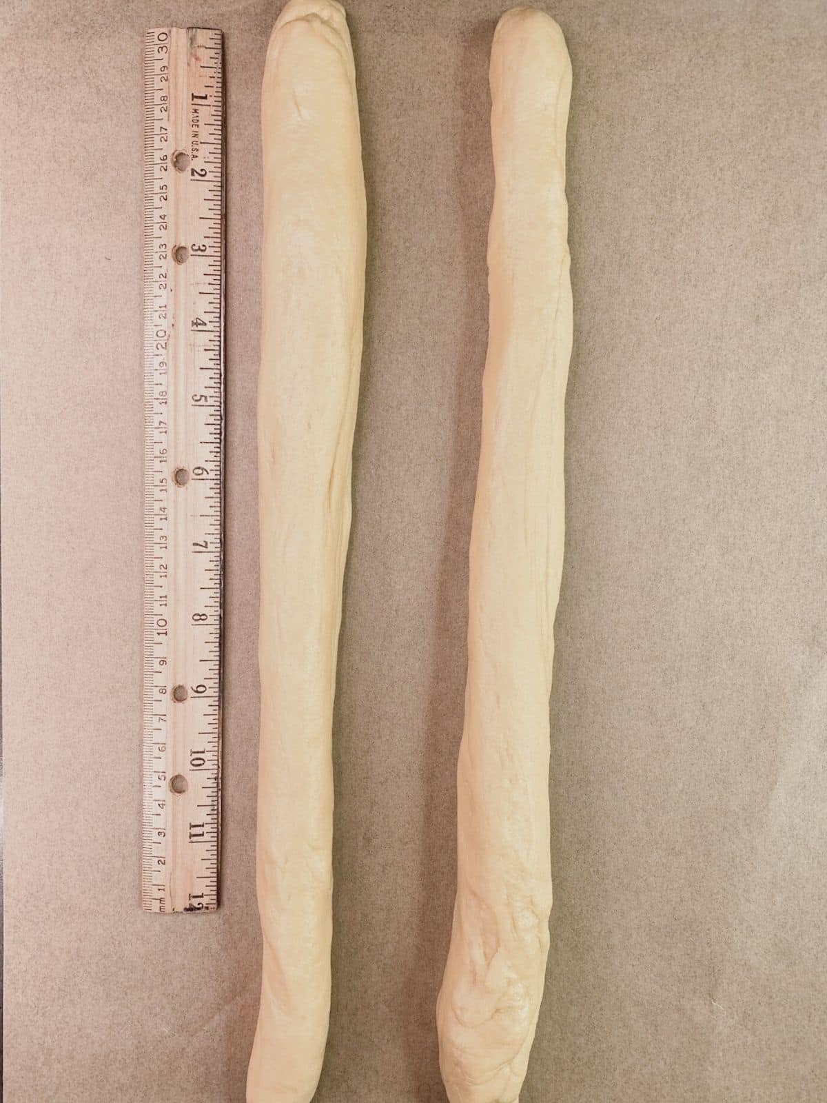2 logs of raw dough with ruler.