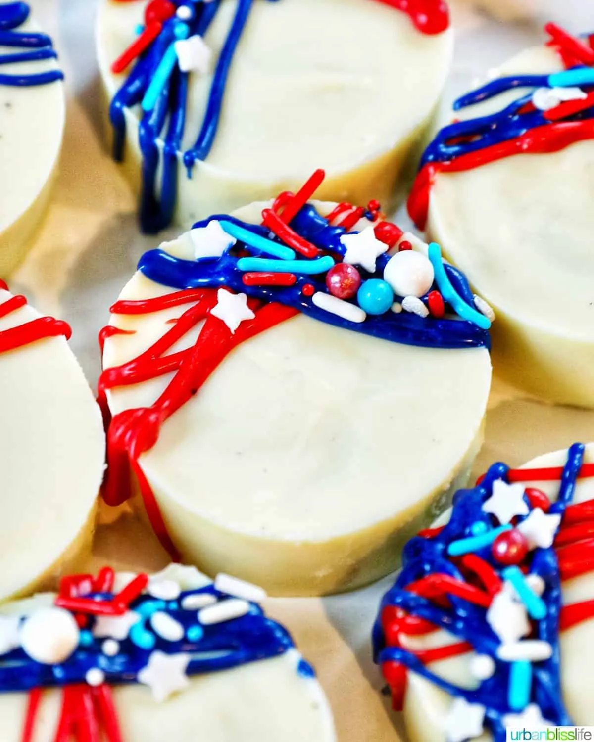 Oreo cookies dipped in white chocolate decorated with patriotic colors.