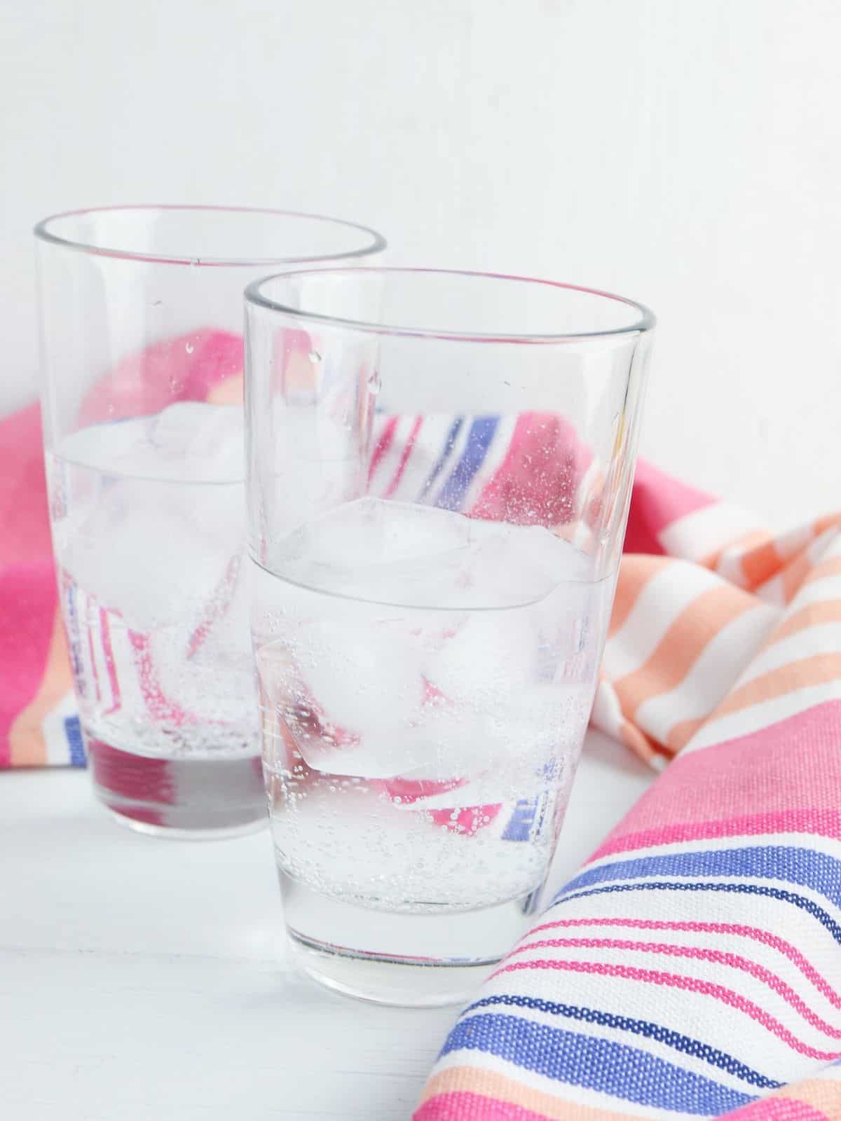 2 glasses of Sprite soda in striped towel.