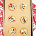 baked cookies on baking rack with parchment paper.