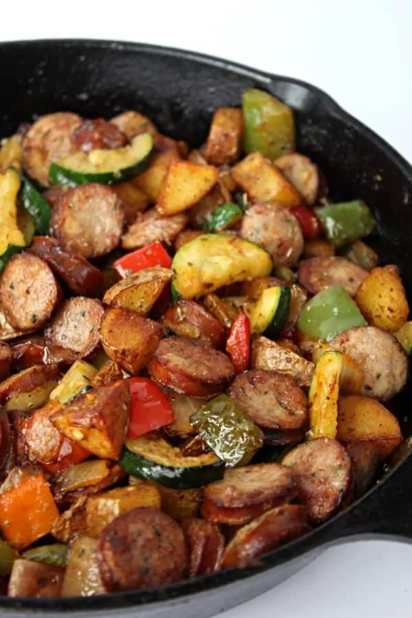 chicken sausage, vegetables and potatoes in cast iron skillet.