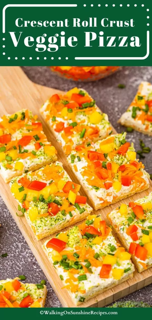 Veggie Pizza made with crescent rolls, cream cheese and chopped veggies on cutting board.