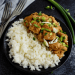 Orange chicken on plate with rice.