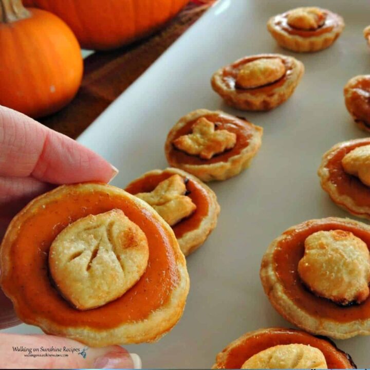 mini pumpkin pies with decorative pie dough crust toppings.