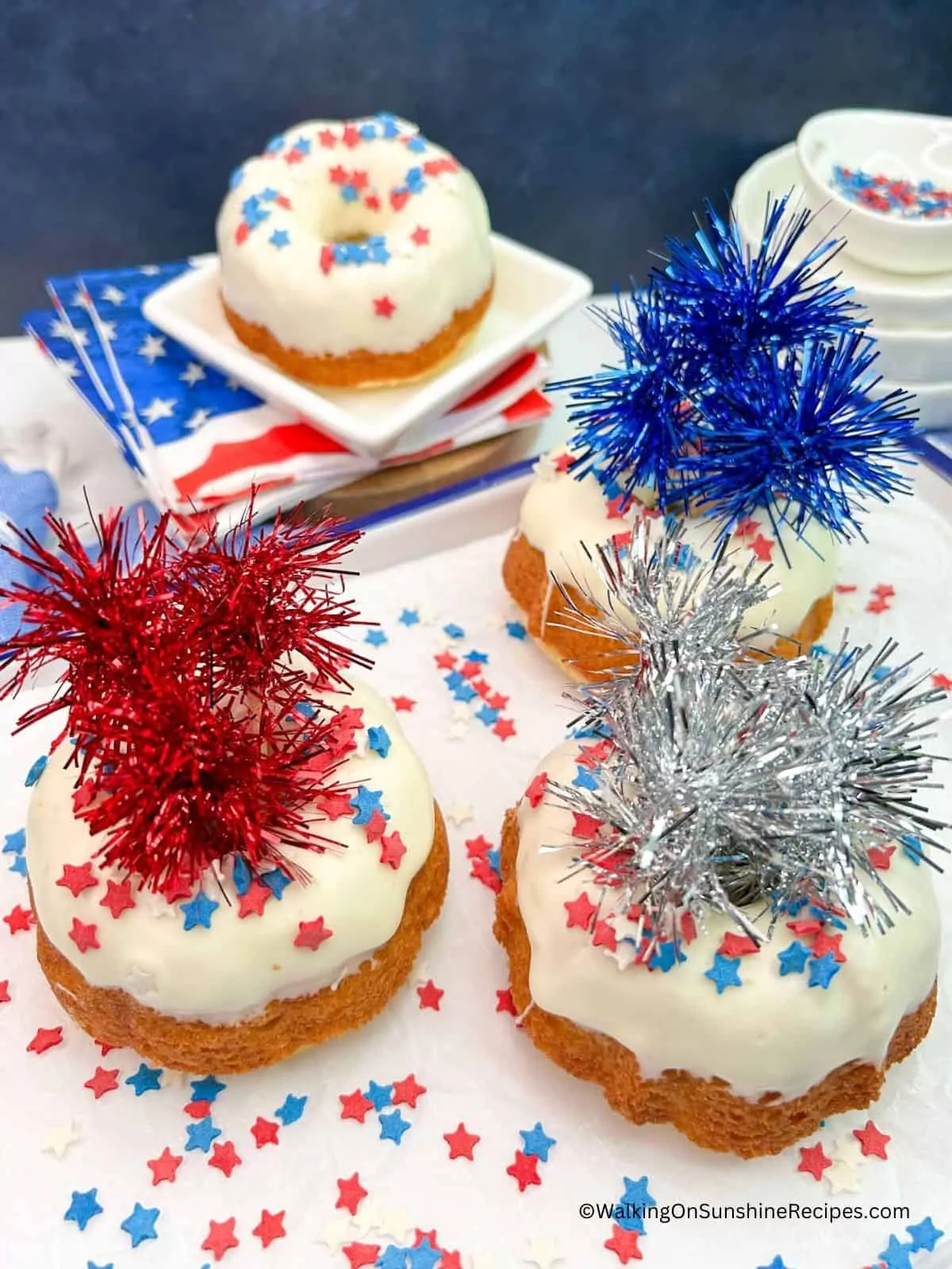 decorated patriotic bundt cakes on white platter.