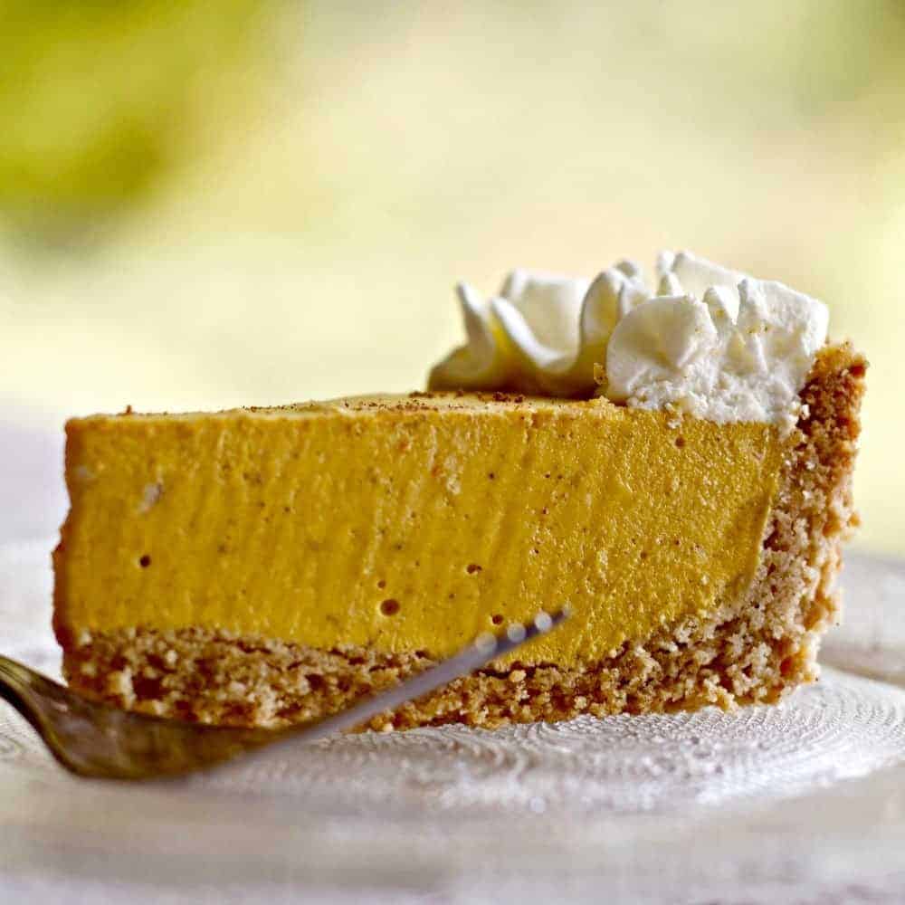 Pumpkin cheesecake on plate with fork.