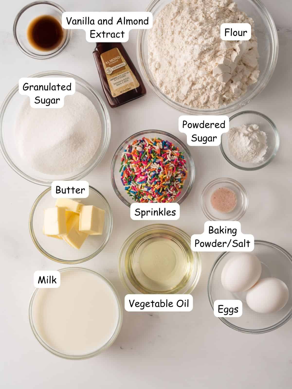 ingredients for homemade muffins with rainbow sprinkles.
