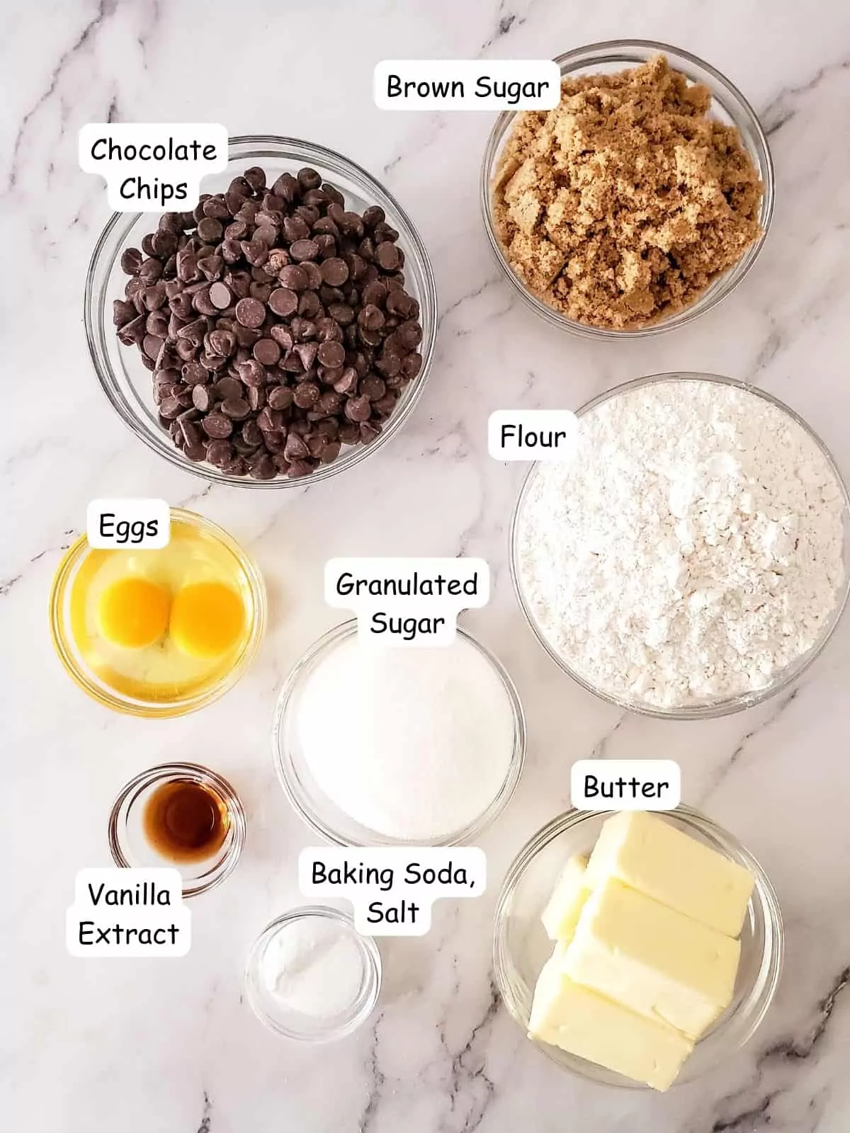 Ingredients for chocolate chip cookies in small bowls.