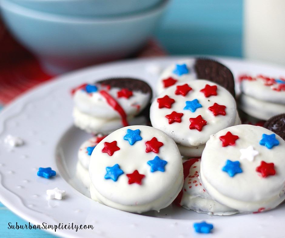 Oreo cookies dipped in white chocolate decorated with red, blue and white star shaped sprinkles.