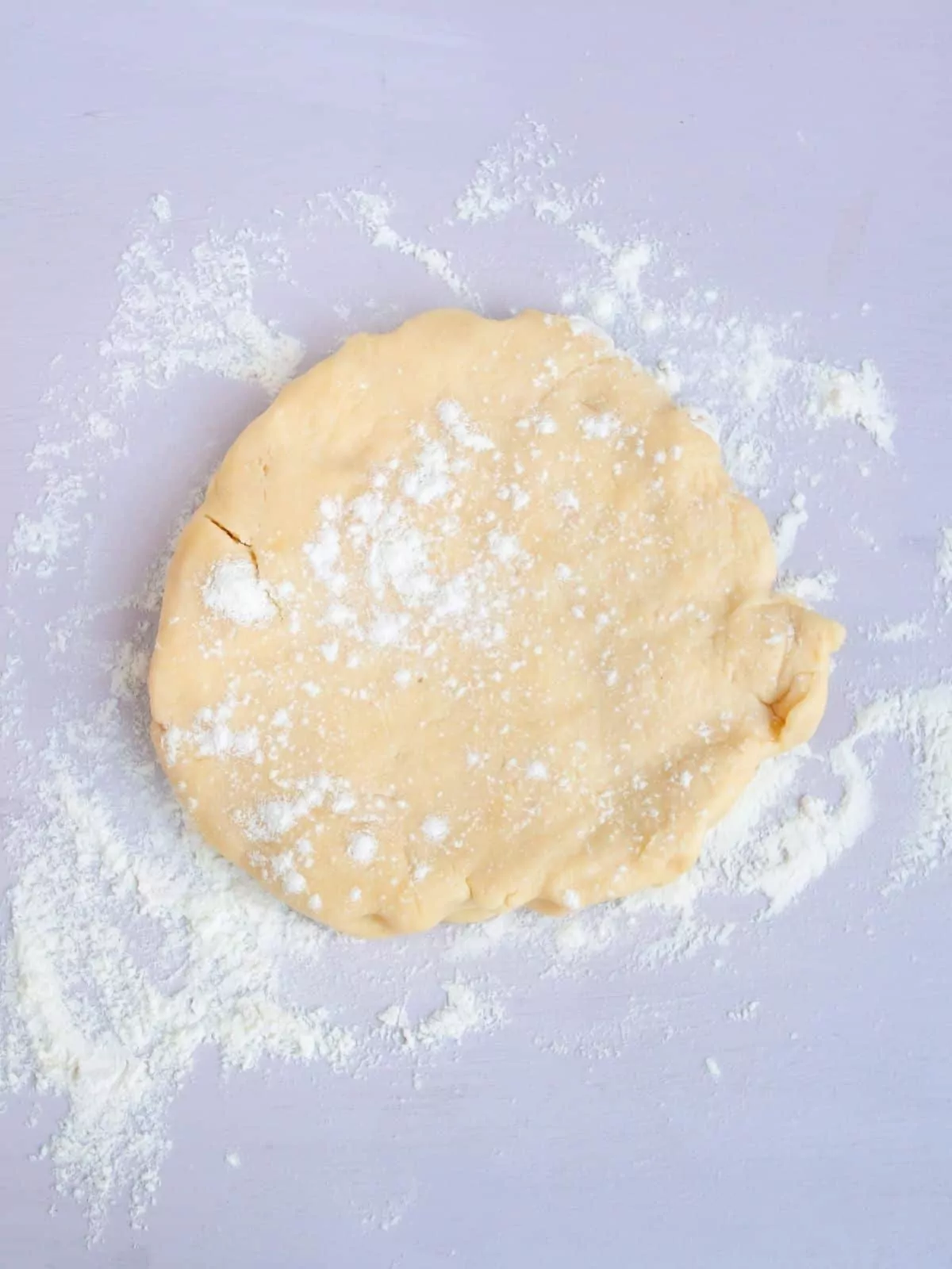 flour sprinkled on top of pie crust dough ready to be rolled out.