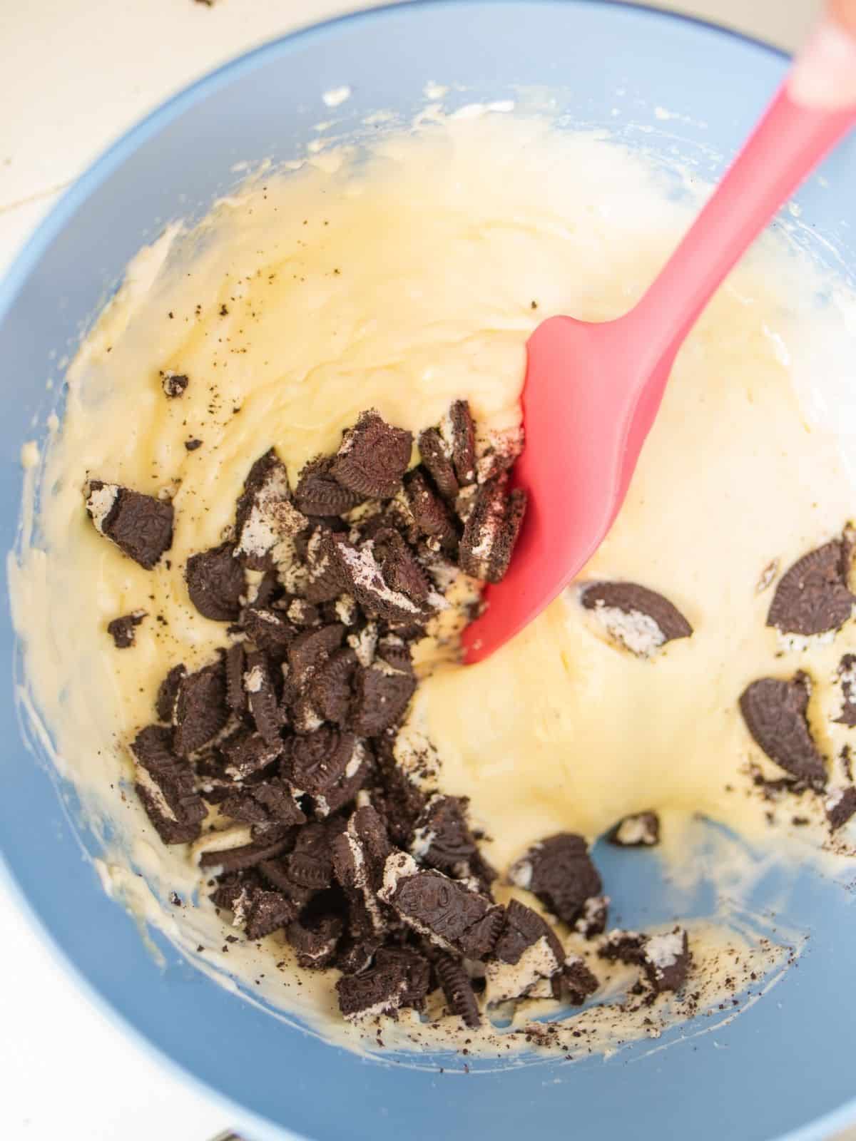 Add Oreo crushed cookies to cream cheese mixture with spatula.