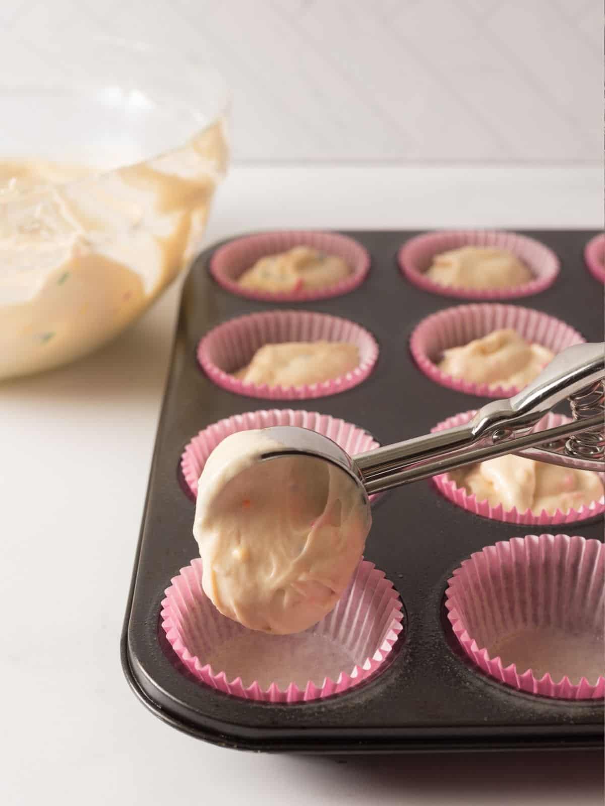 use ice cream scoop to add batter to muffin pan.