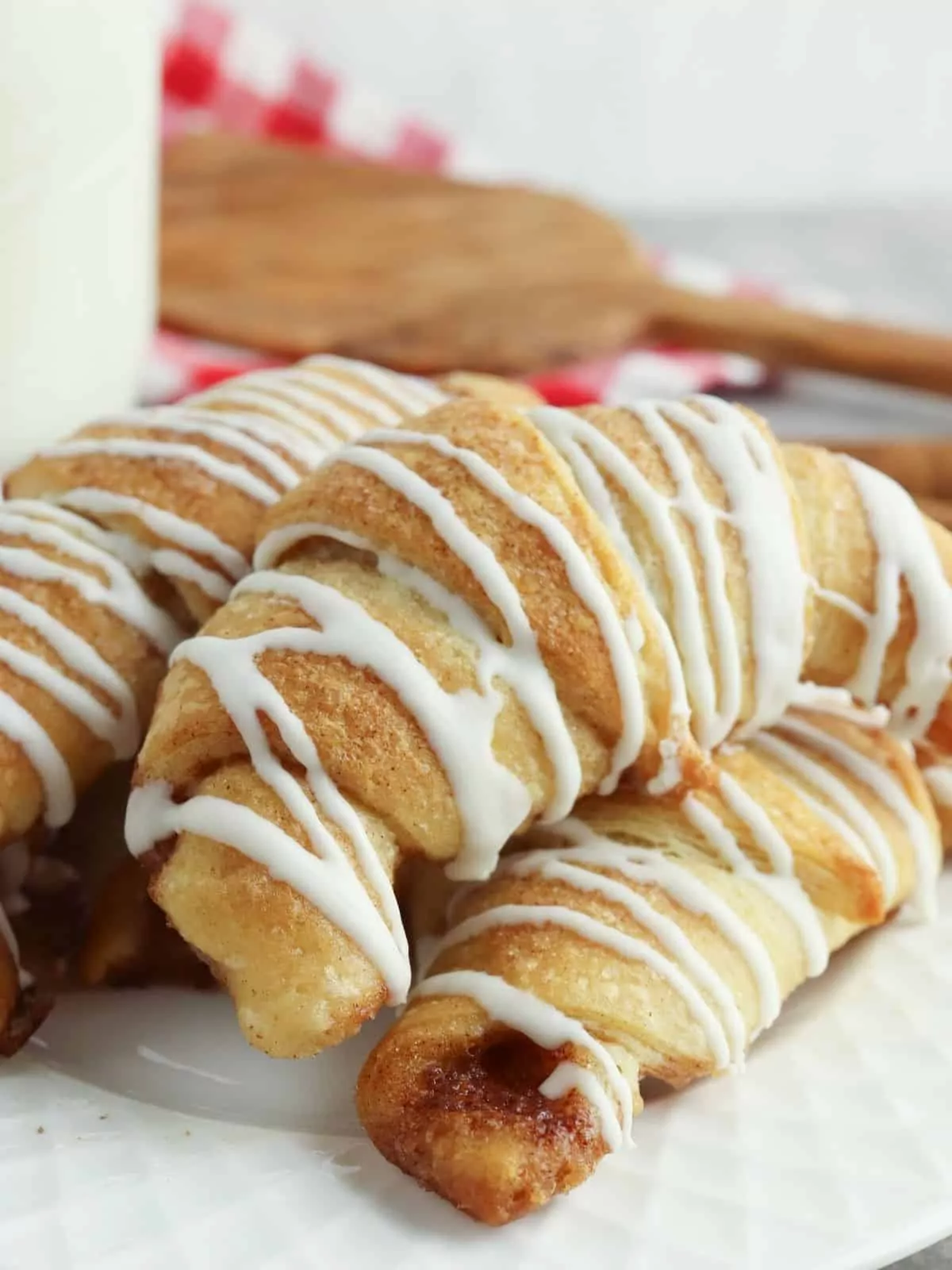 closeup of cinnamon sugar crescent rolls with cream cheese drizzle.