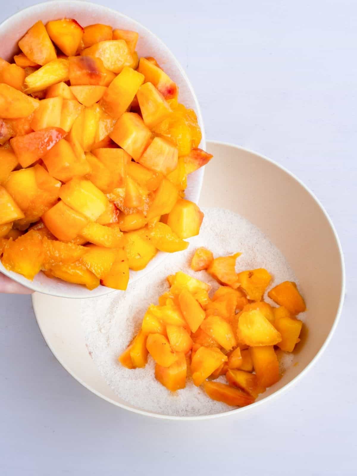 add diced peaches to bowl with flour, cinnamon mixture.
