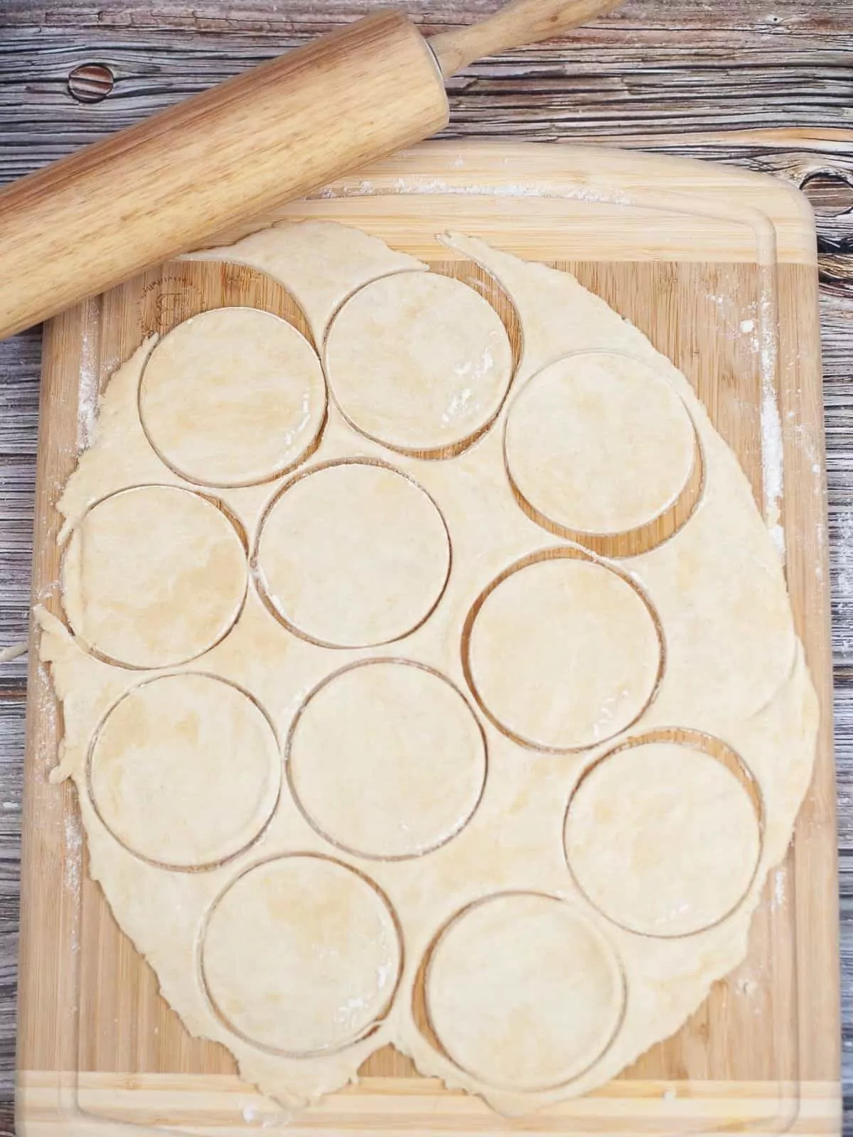 pie dough circles cut out on cutting board.