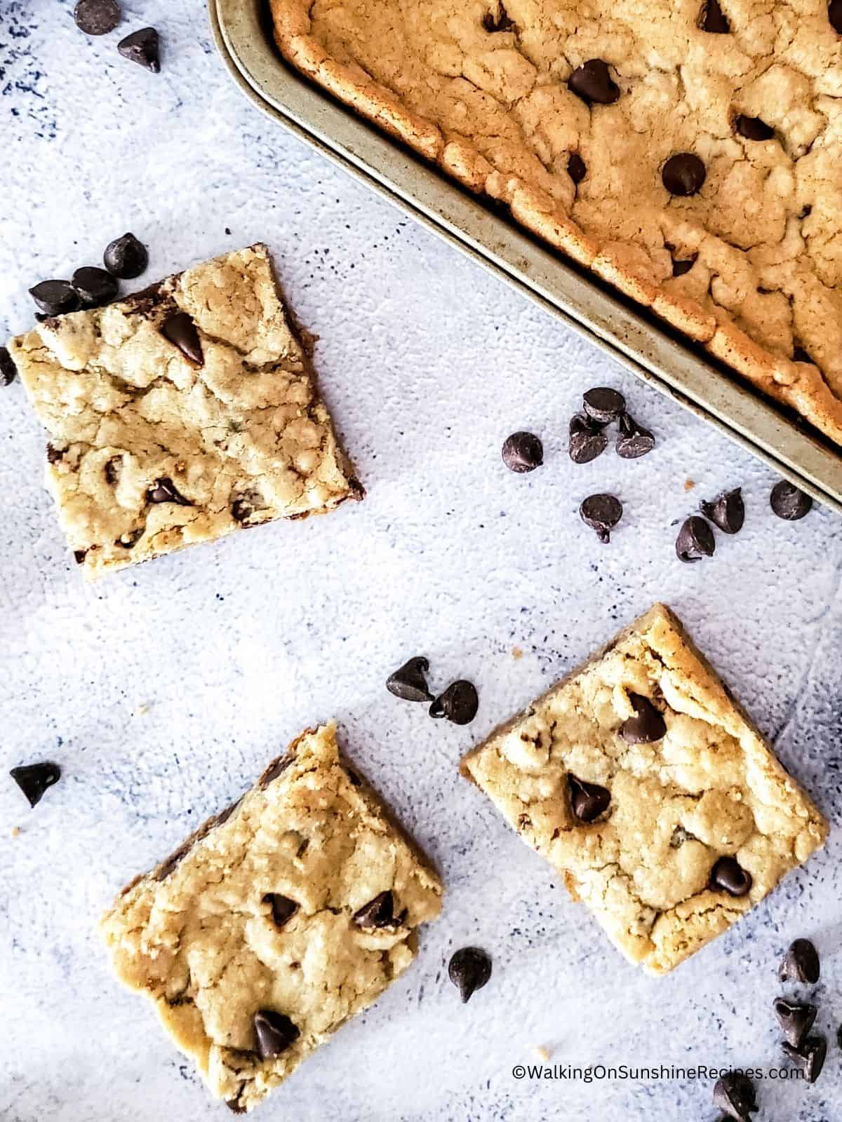 sliced bar cookies with pan cookies in background.