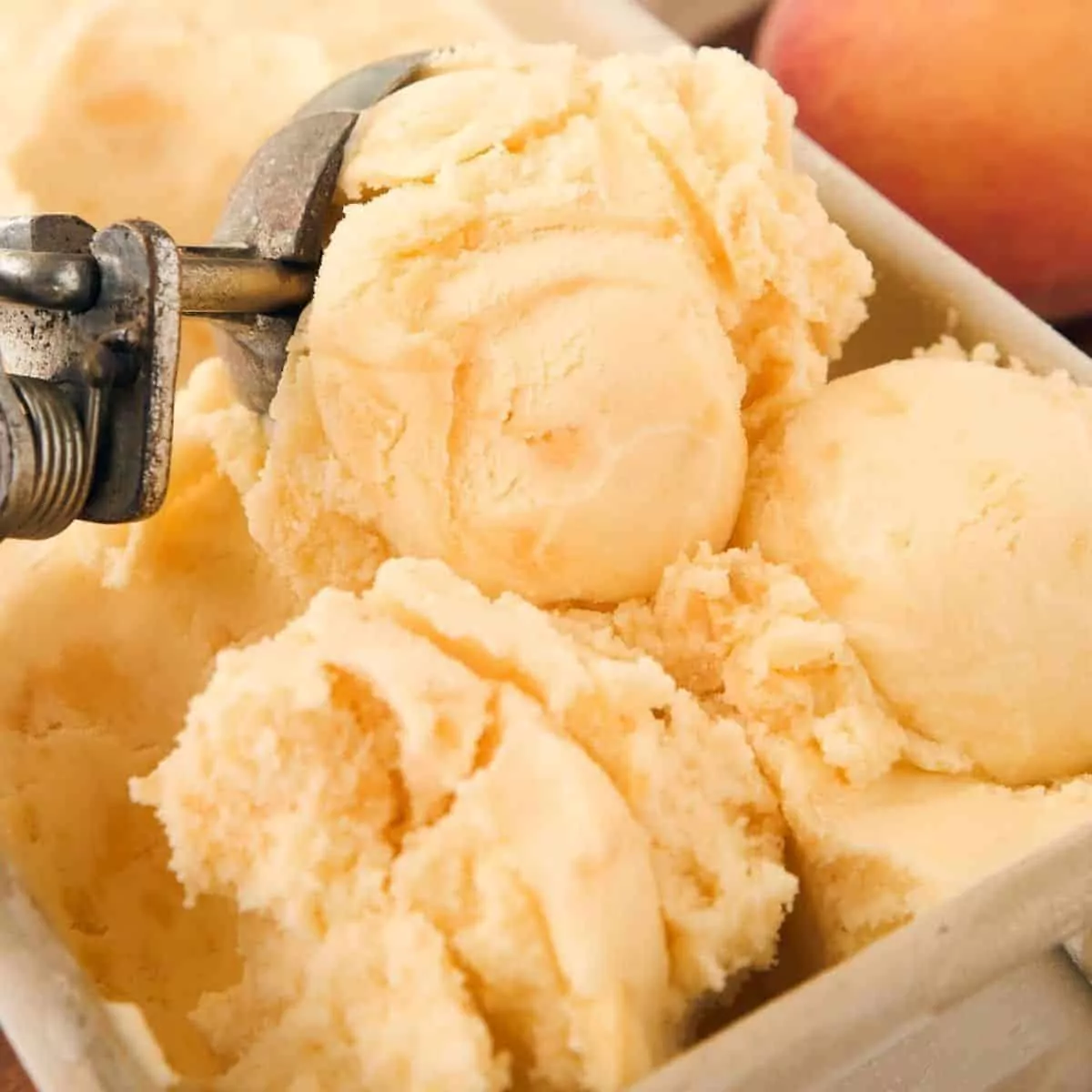 peach ice cream with scoop.