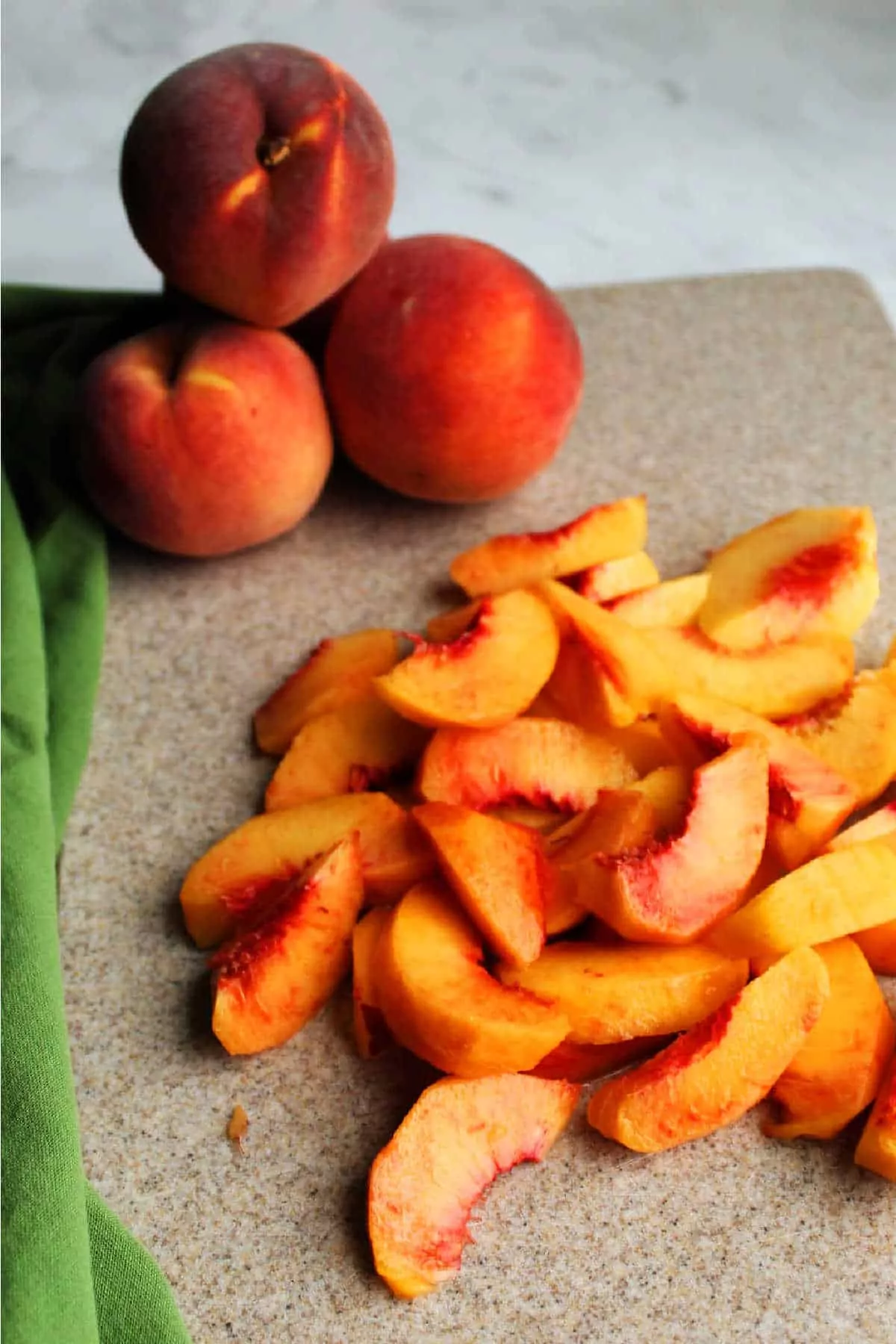 sliced peaches on cutting board.