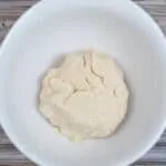 pie dough formed into ball in white bowl.