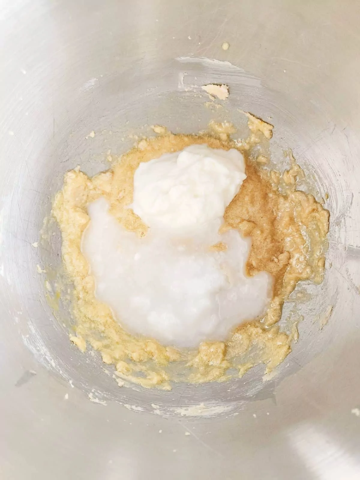 Add Greek yogurt with melted coconut oil to butter and sugar mixture.