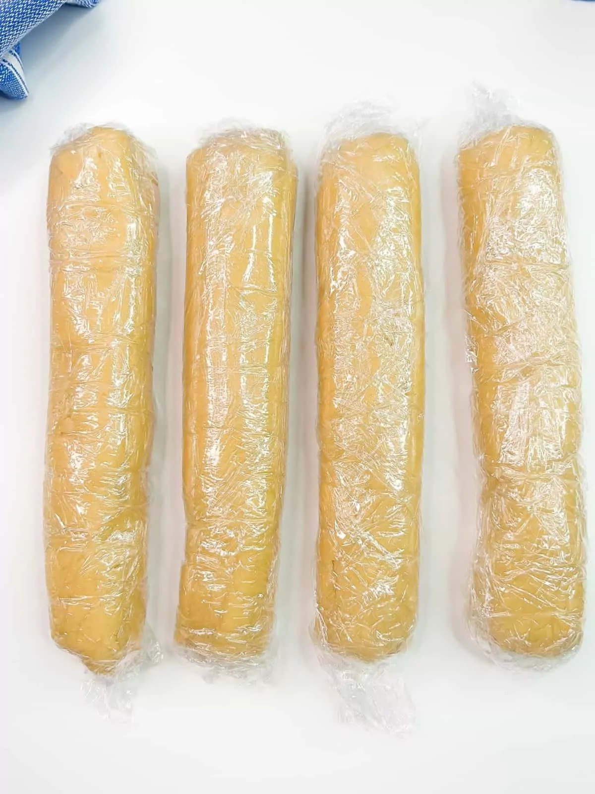cookie dough logs wrapped in plastic wrap.