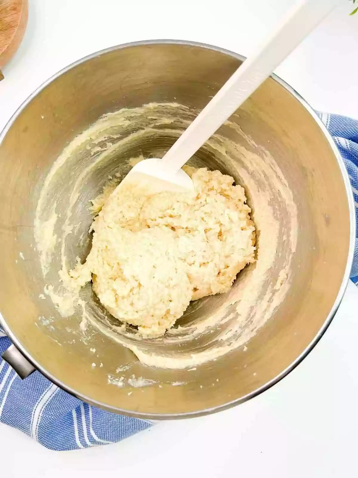 cookie dough in mixing bowl with rubber spatula.