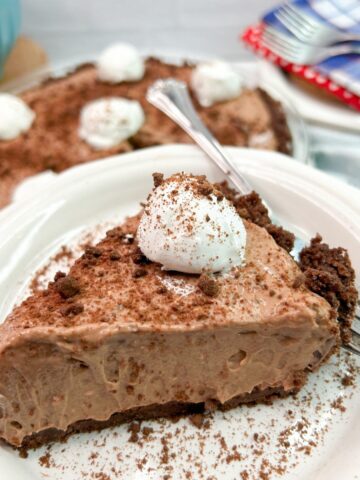 slice of chocolate cheesecake pudding pie served on a white plate.
