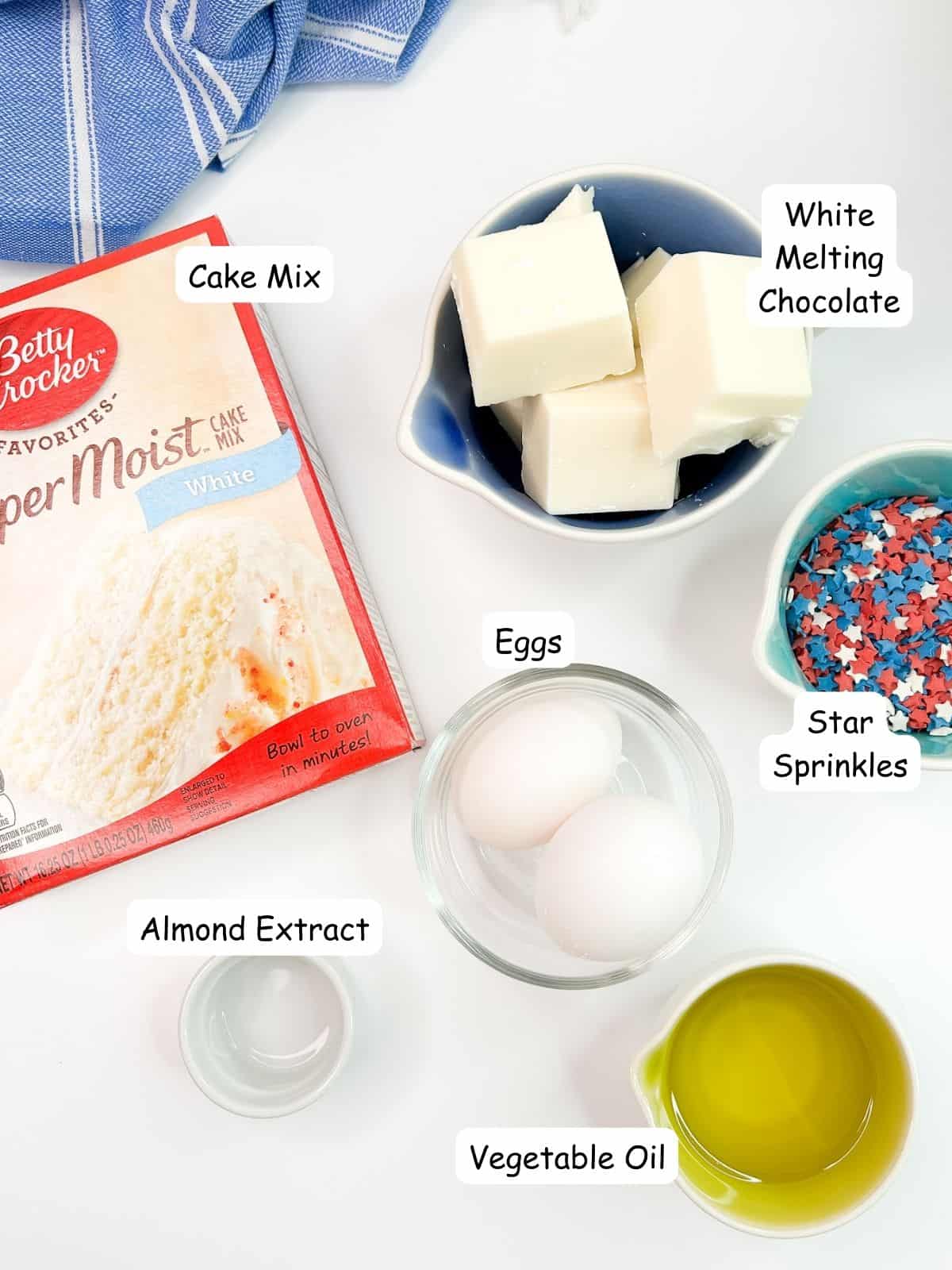 Patriotic Cake Mix cookies ingredients, cake mix, vegetable oil, eggs, sprinkles, almond extract and white chocolate.