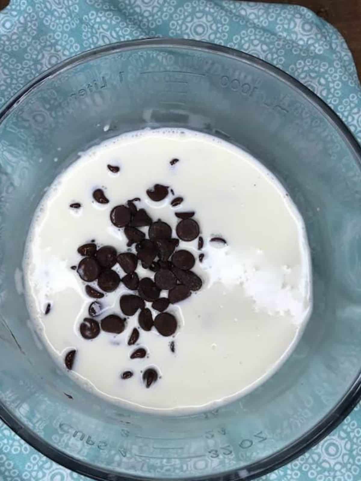 heavy cream and chocolate chips in glass bowl.