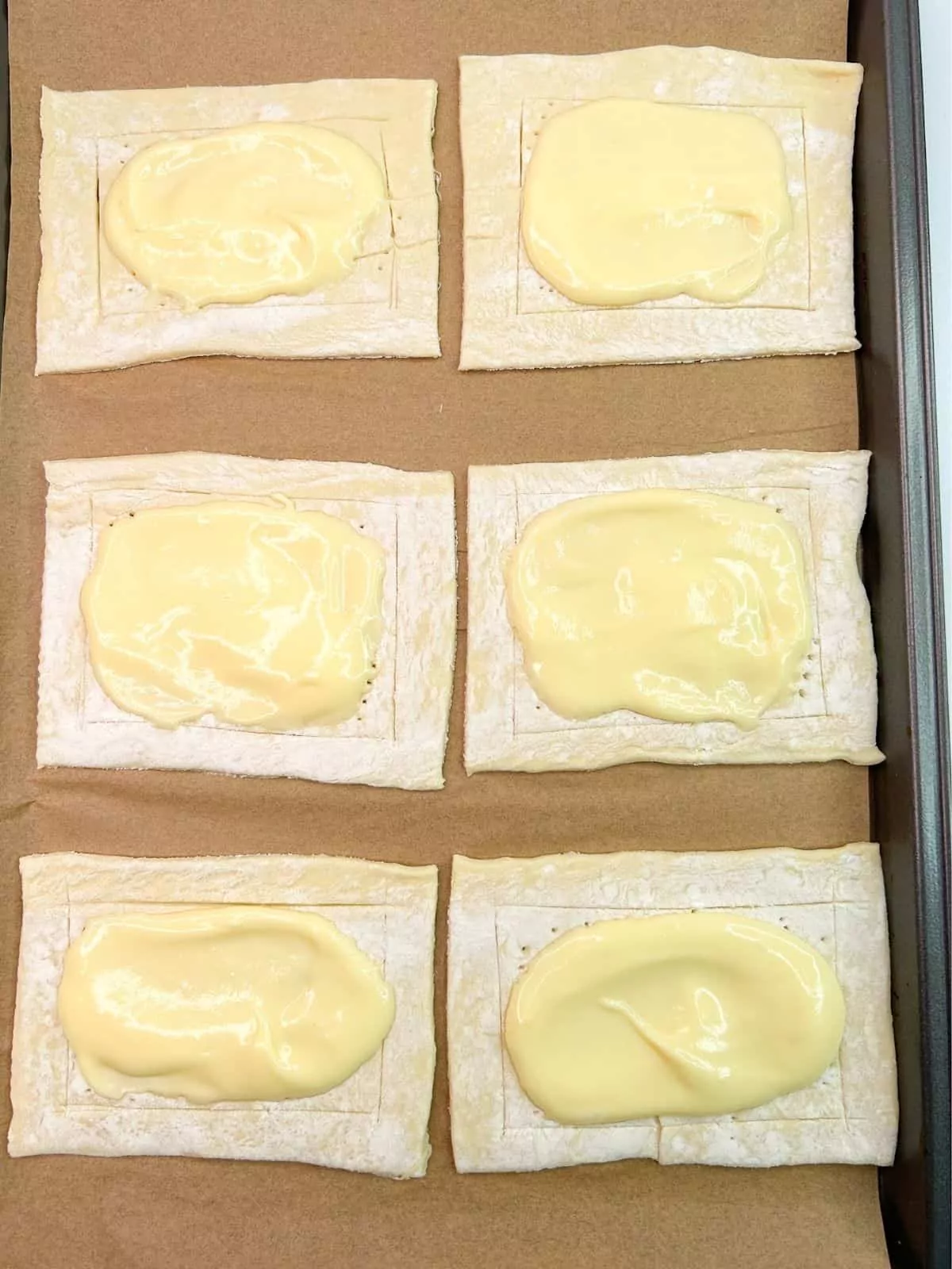 add cream cheese filling to top of puff pastry.