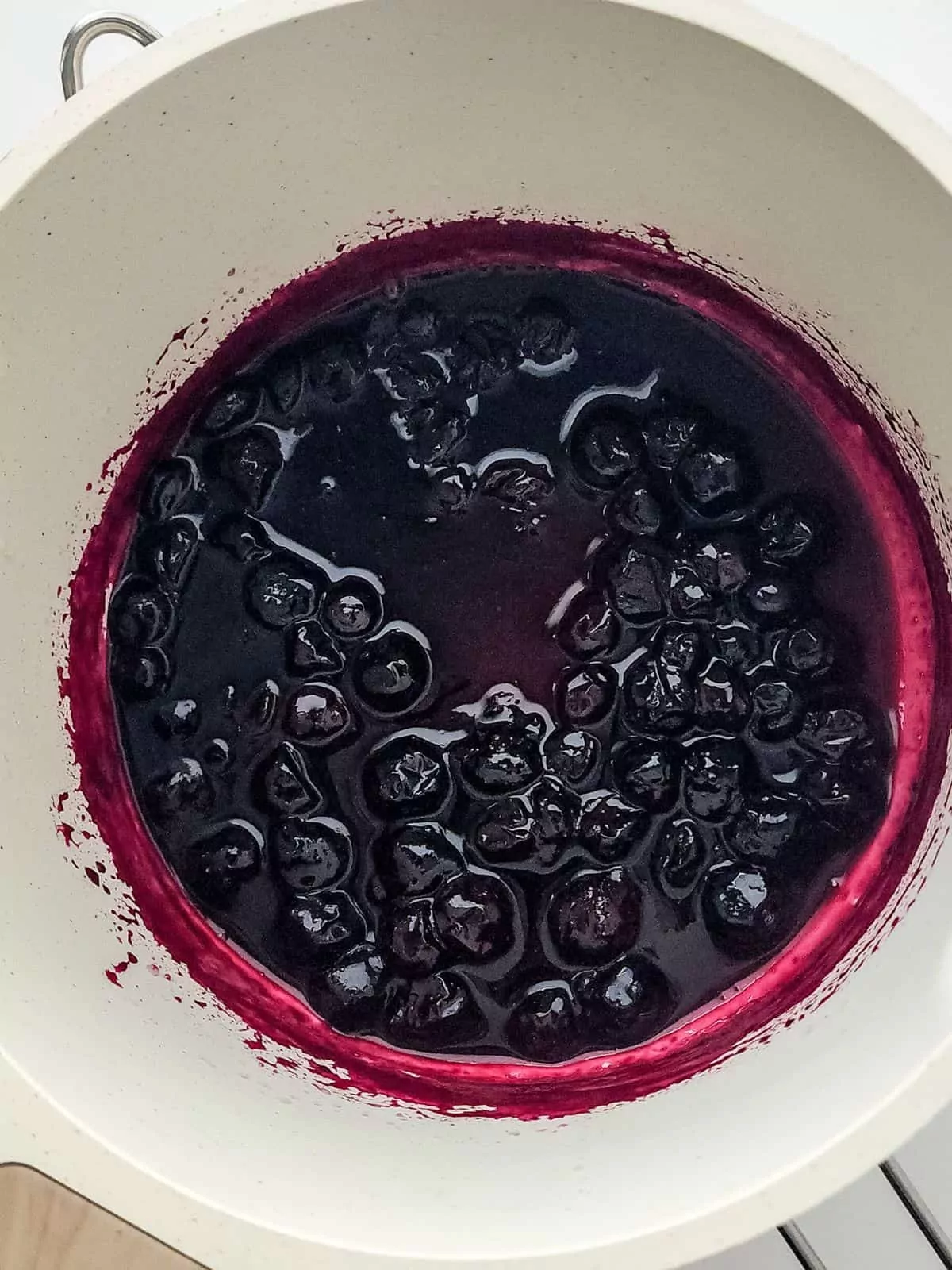cooked blueberry sauce in pot.