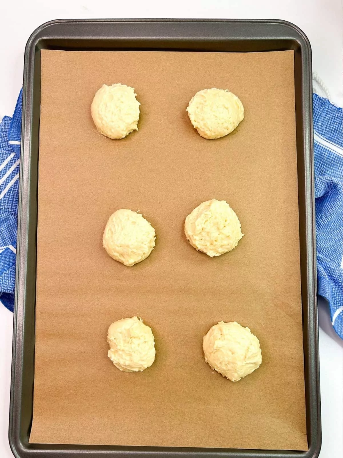 cookie dough on pan lined with parchment paper