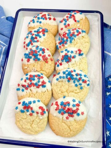 4th of July Cake Mix Cookies dipped in white chocolate and sprinkled with patriotic sprinkles.