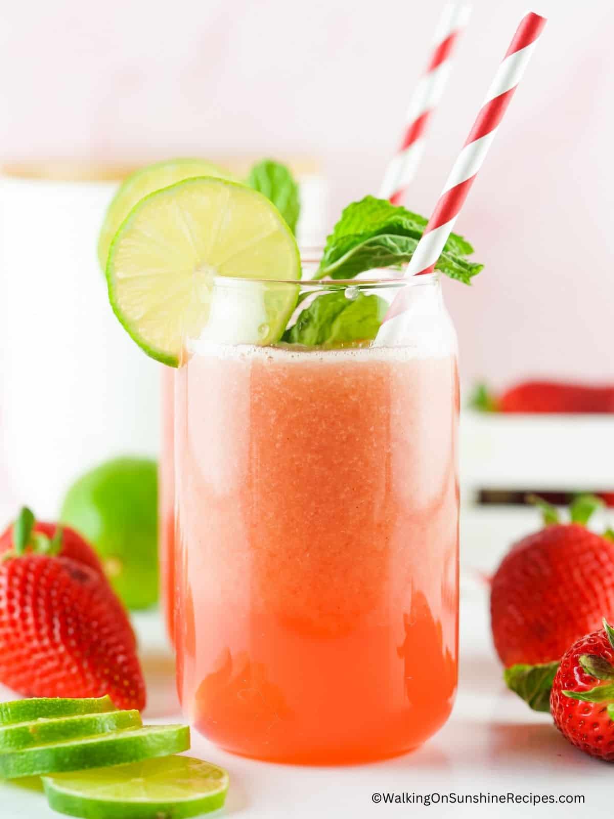strawberry lime water in glass with straws.