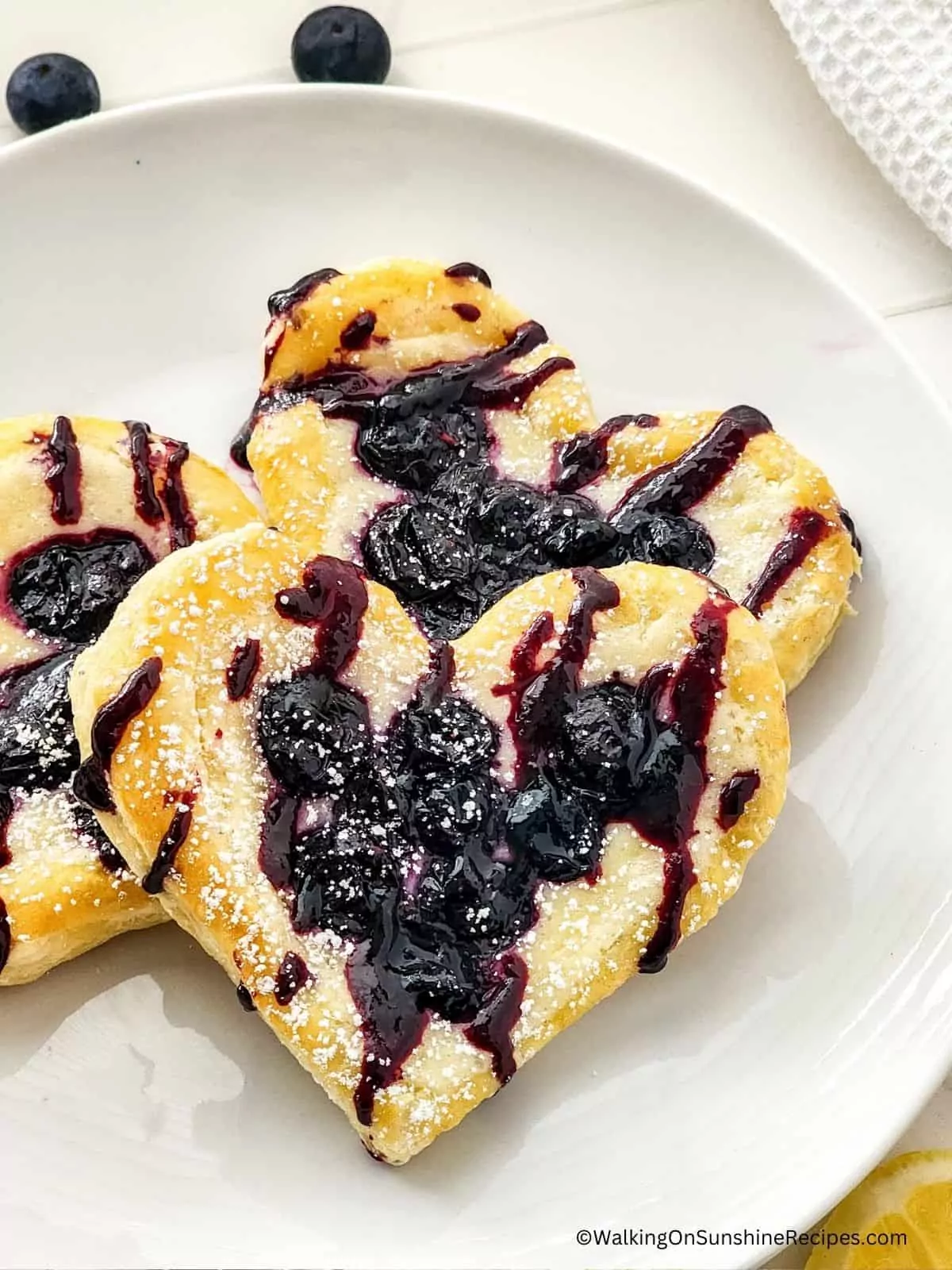 heart shaped purr pastry danish with blueberries.