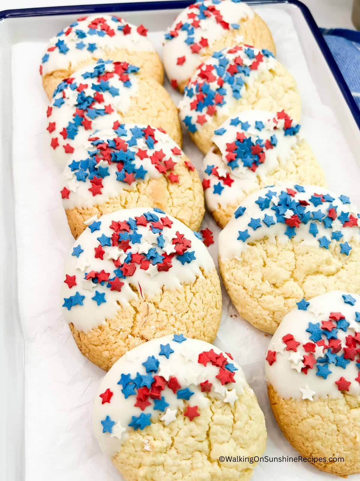 4th of July Cake Mix Cookies dipped in white chocolate and patriotic sprinkles on the chocolate.