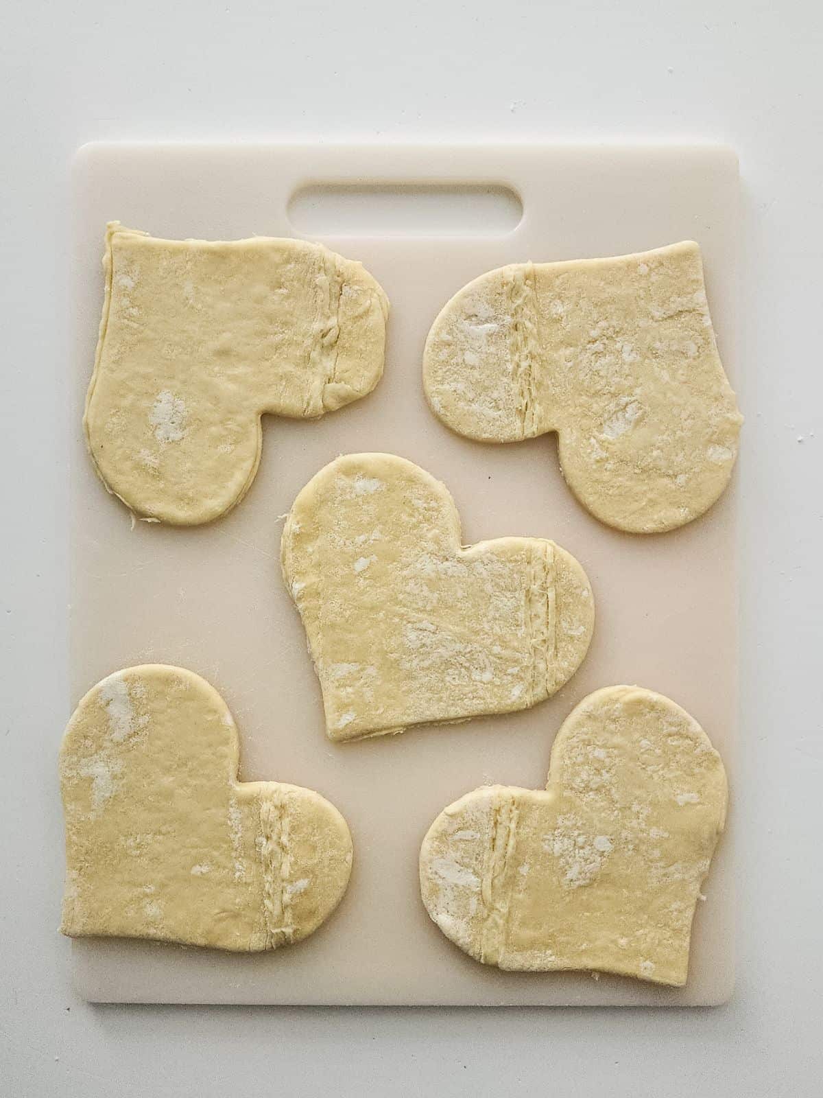 puff pastry hearts on cutting board.