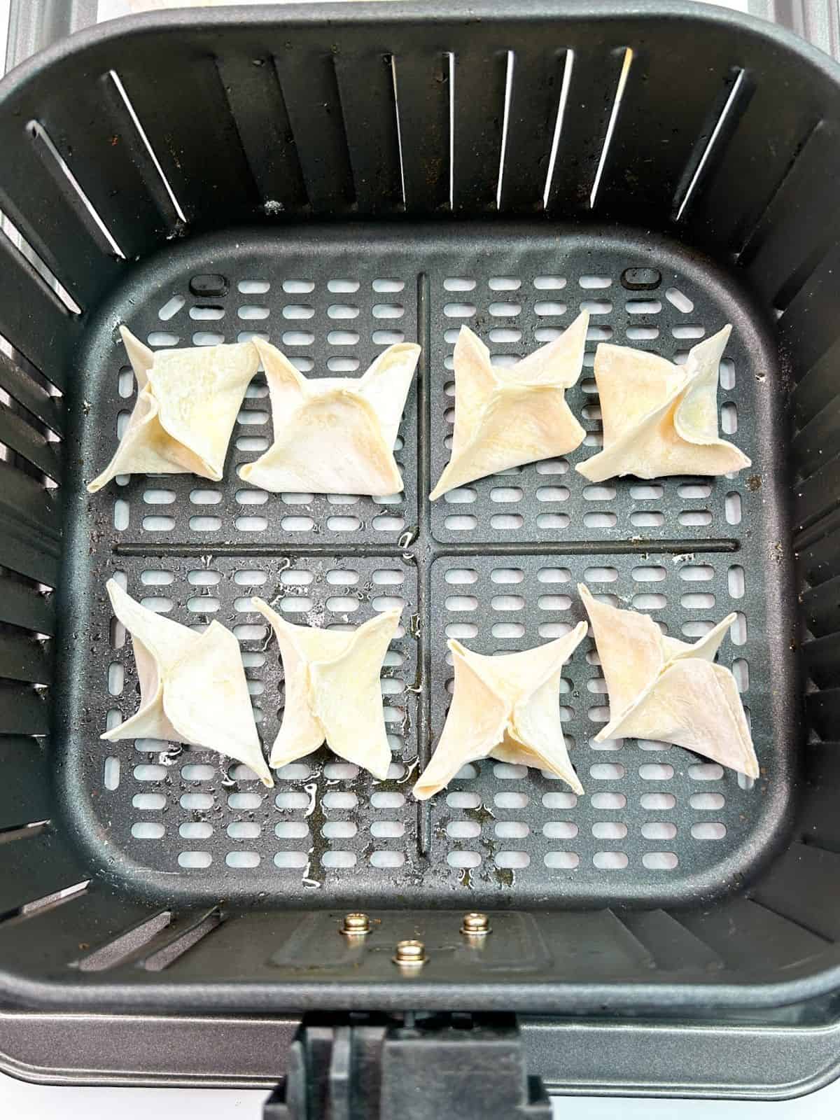 Won Tons in air fryer before cooking.