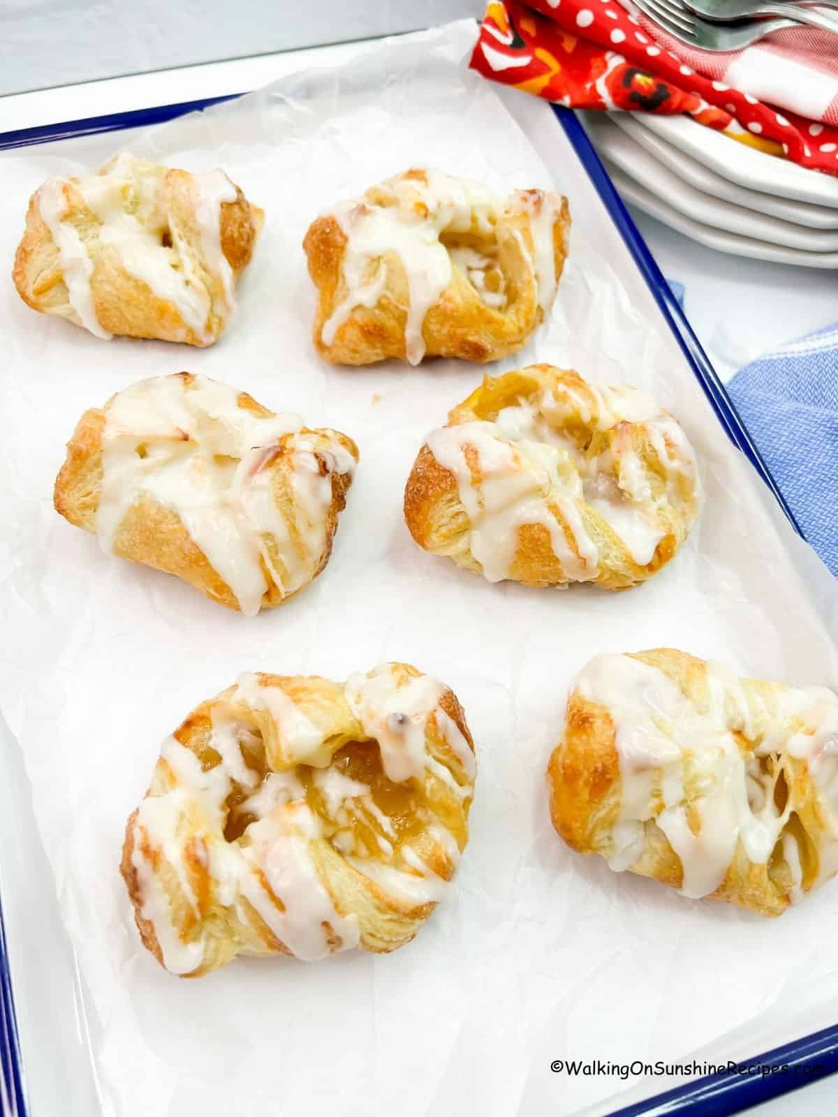 Apple Danish on a blue rimmed baking sheet