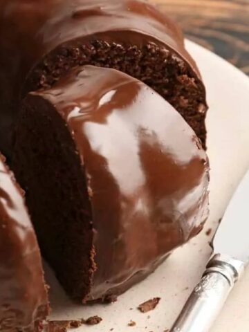 A chocolate bundt cake with a slice cut out.
