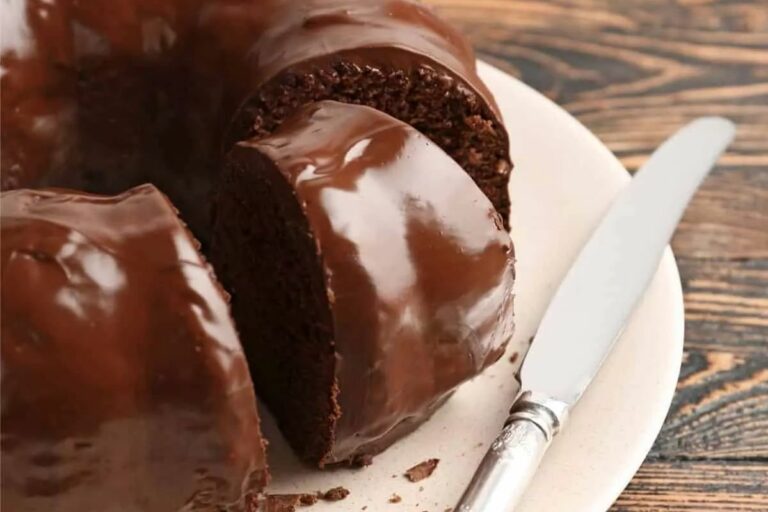 A chocolate bundt cake with a slice cut out.