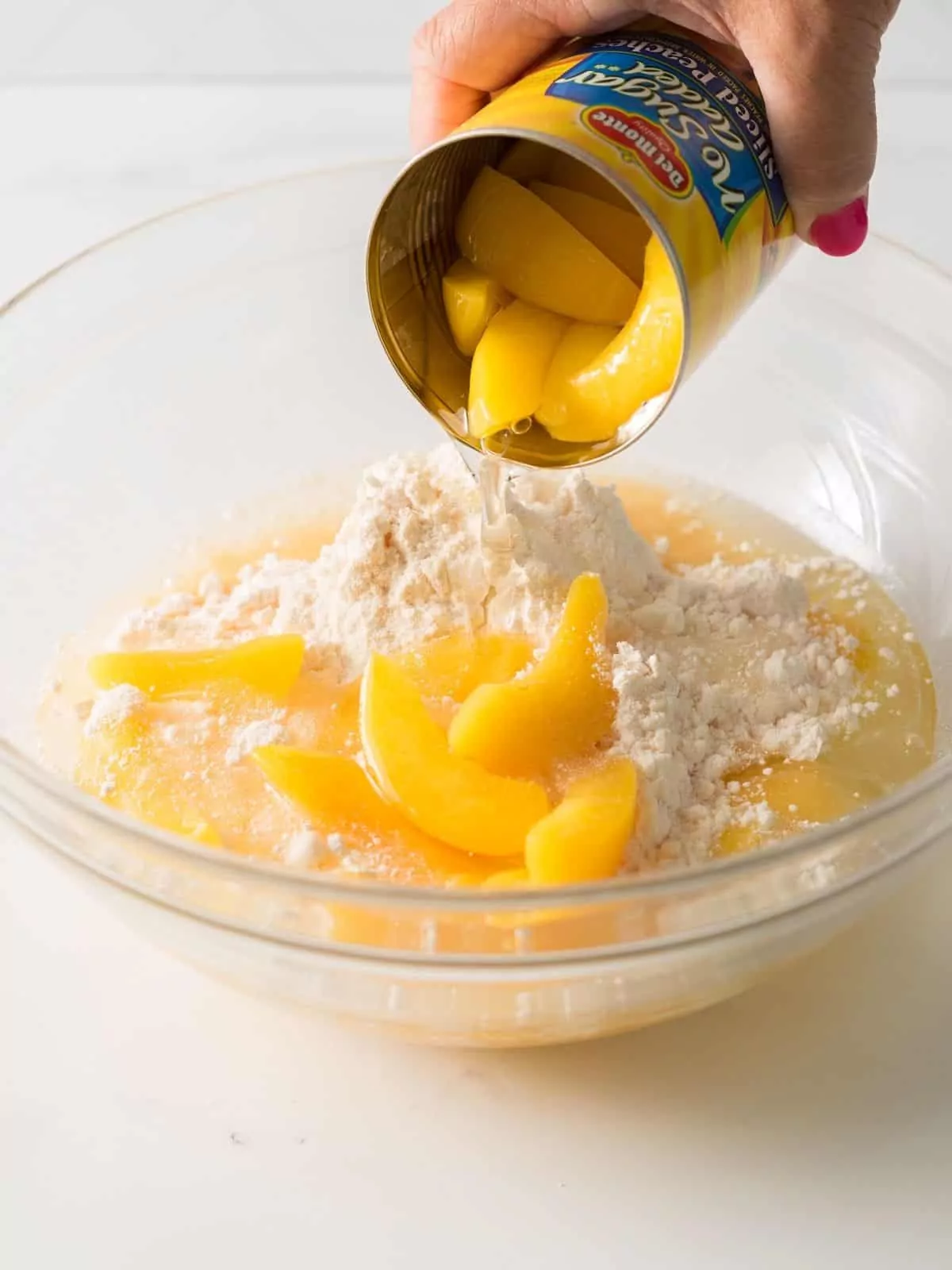 Add canned peaches to cake mix.