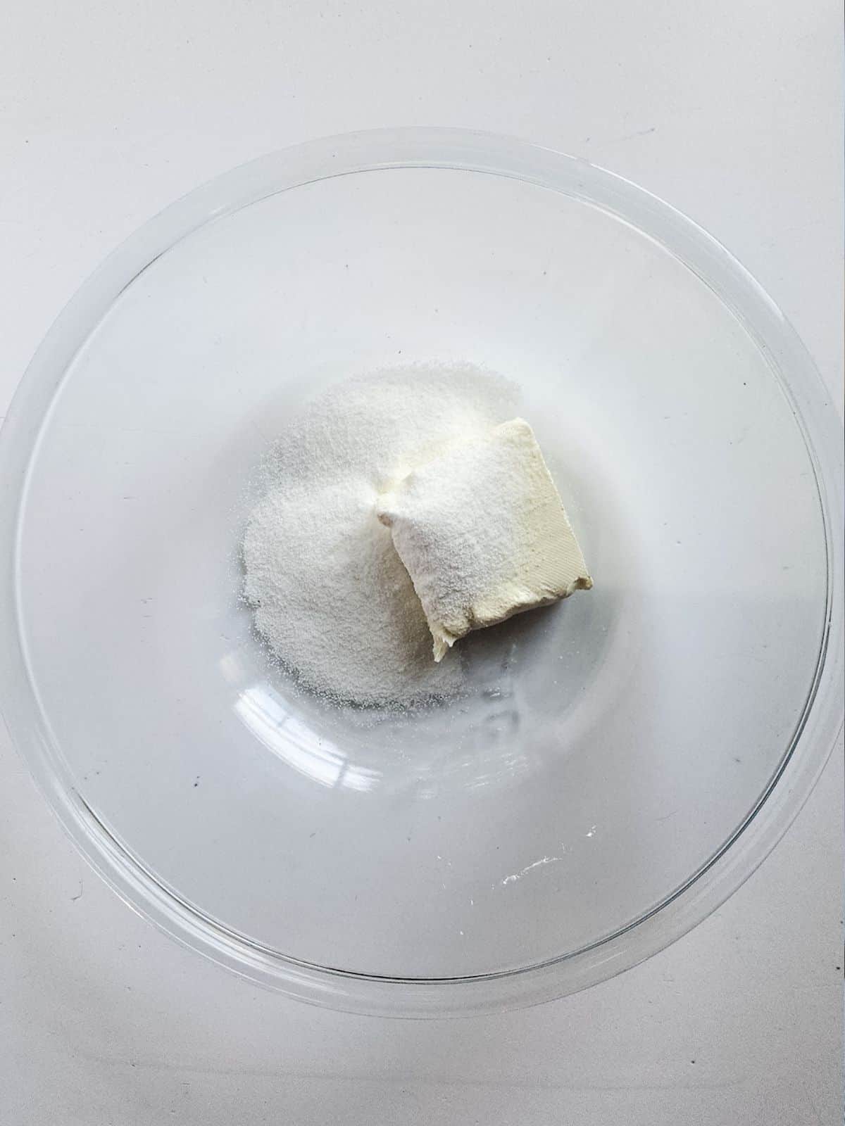 cream cheese with sugar in glass bowl.