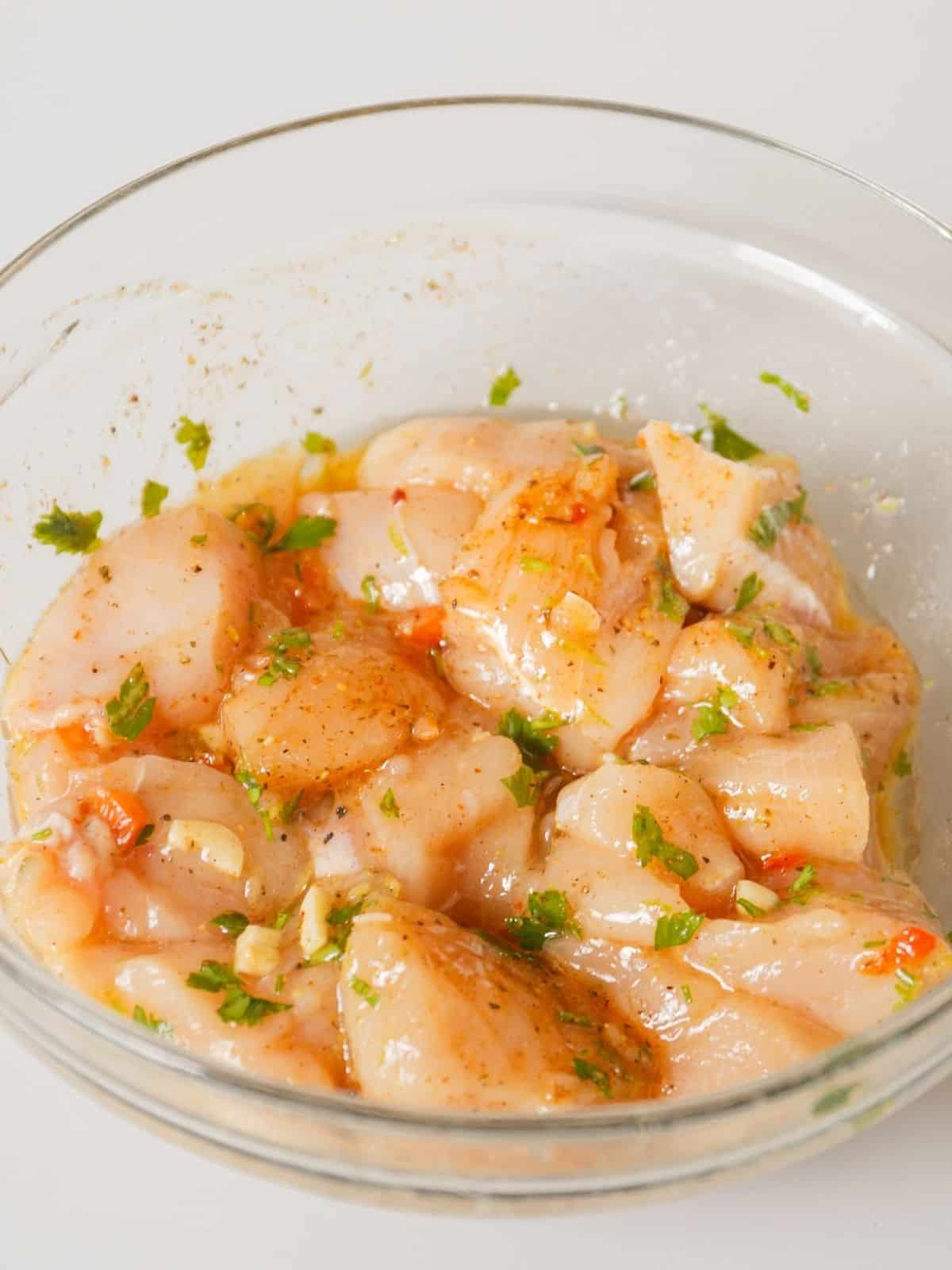 cubed chicken pieces in marinade.